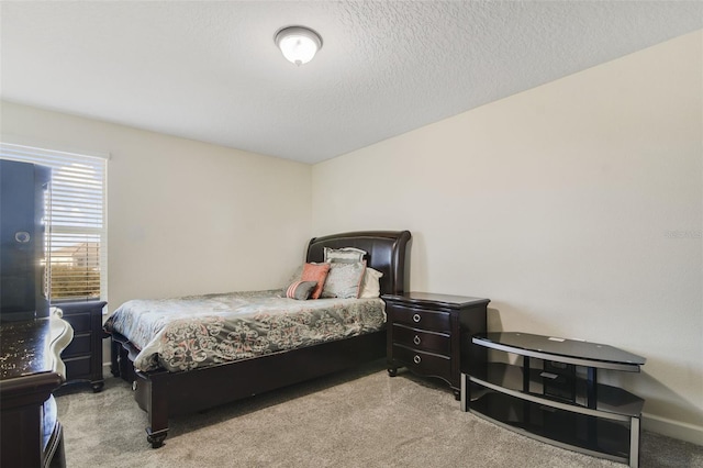 carpeted bedroom with a textured ceiling