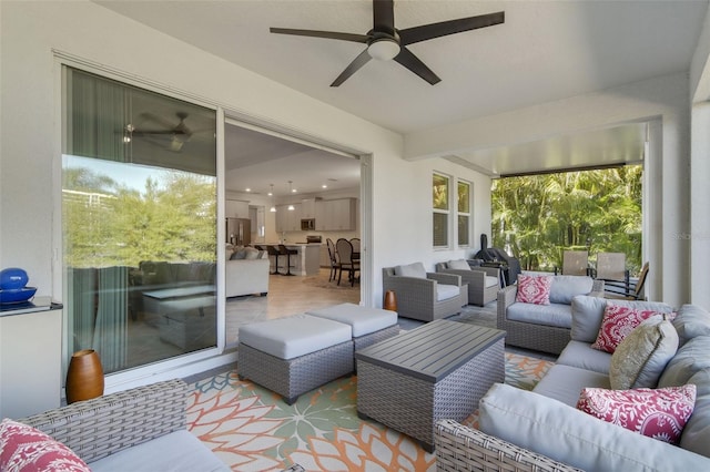 sunroom featuring ceiling fan