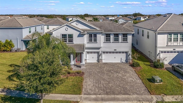 view of front of house with a front yard and a garage