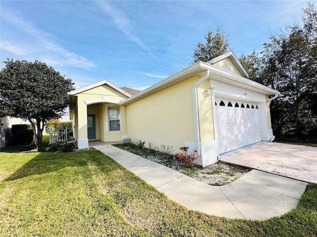 view of front of home with a garage and a front lawn