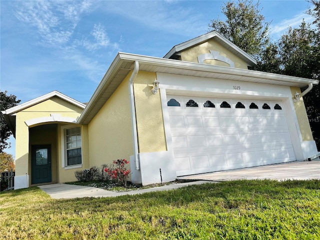 view of front of property with a front yard and a garage