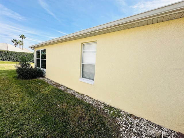 view of side of home with a lawn