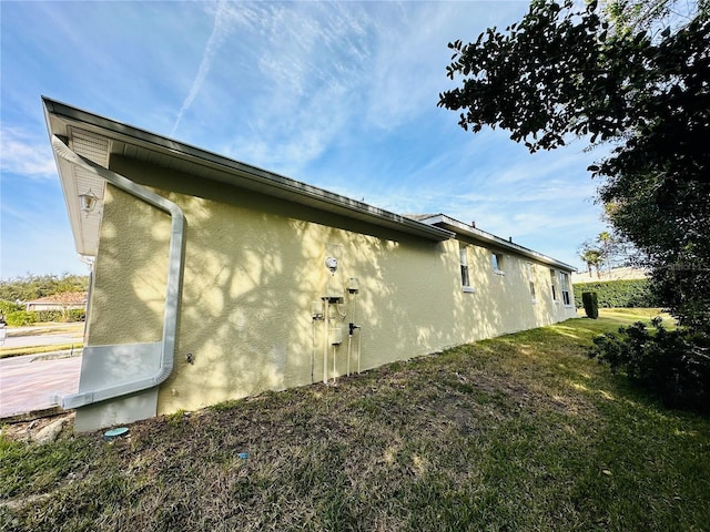 view of home's exterior with a lawn