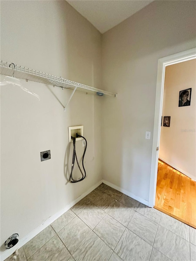 washroom featuring hookup for a washing machine and light hardwood / wood-style flooring