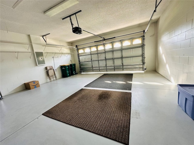 garage featuring electric panel and a garage door opener