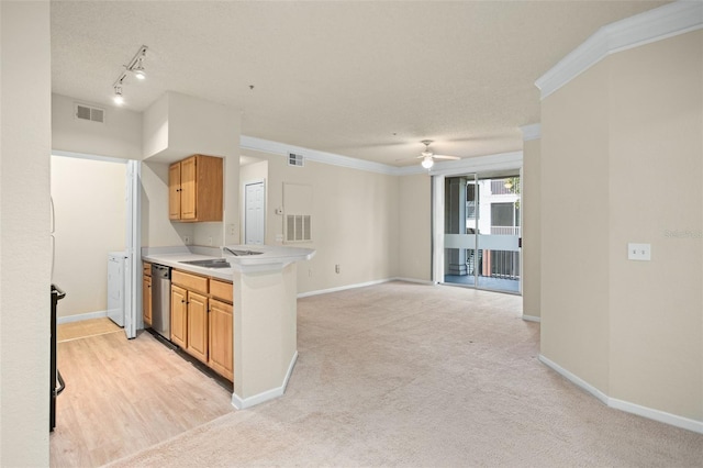 kitchen with dishwasher, ceiling fan, ornamental molding, and light carpet