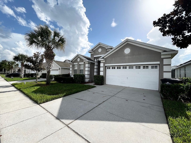 view of front of house featuring a garage and a front lawn