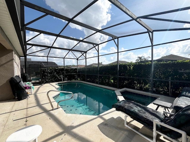 view of swimming pool featuring a lanai, a patio, and an in ground hot tub