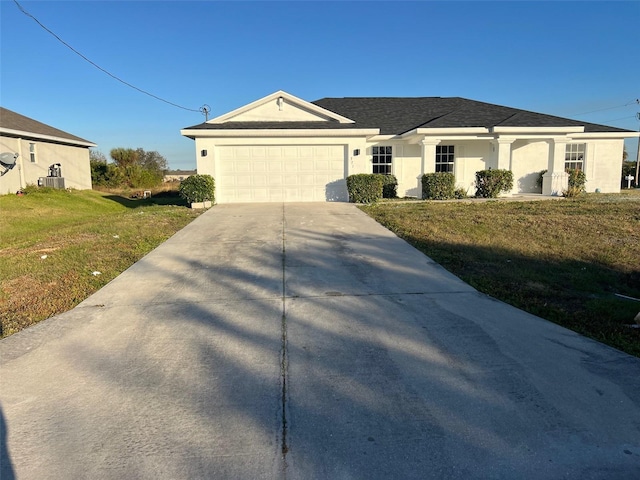 single story home with a front yard, a garage, and cooling unit