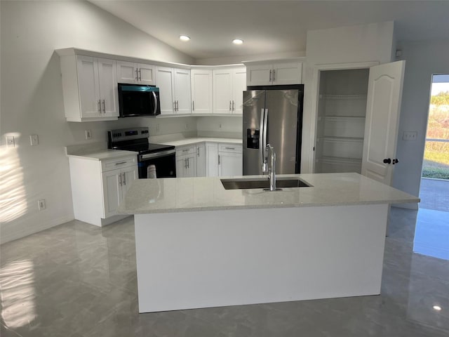 kitchen featuring light stone countertops, stainless steel appliances, vaulted ceiling, sink, and white cabinets