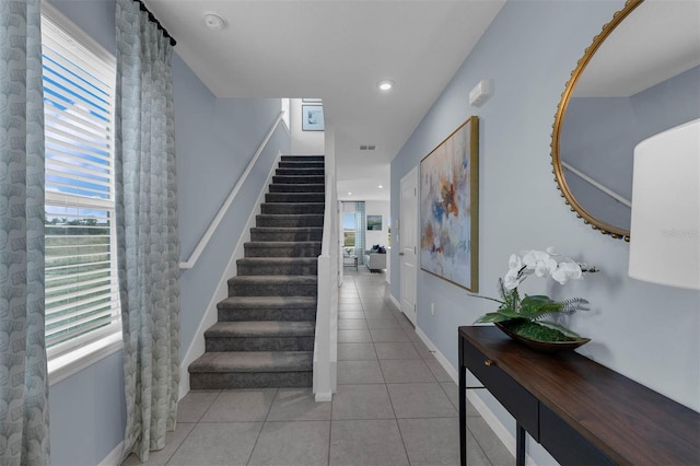 staircase featuring tile patterned flooring