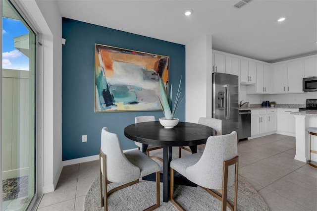 dining area featuring light tile patterned floors