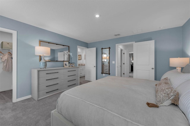 carpeted bedroom with a spacious closet and a closet