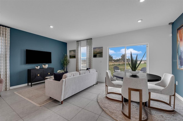 living room with a wealth of natural light and light tile patterned flooring