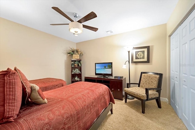 carpeted bedroom featuring a closet and ceiling fan