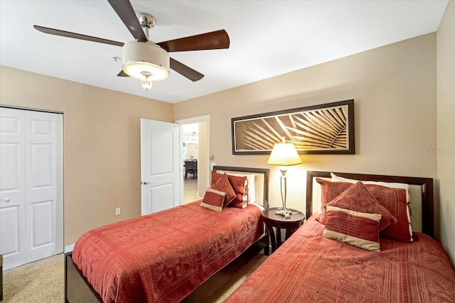 carpeted bedroom featuring a closet and ceiling fan