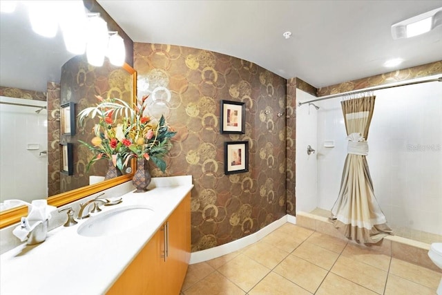 bathroom featuring tile patterned flooring, a shower with curtain, vanity, and toilet