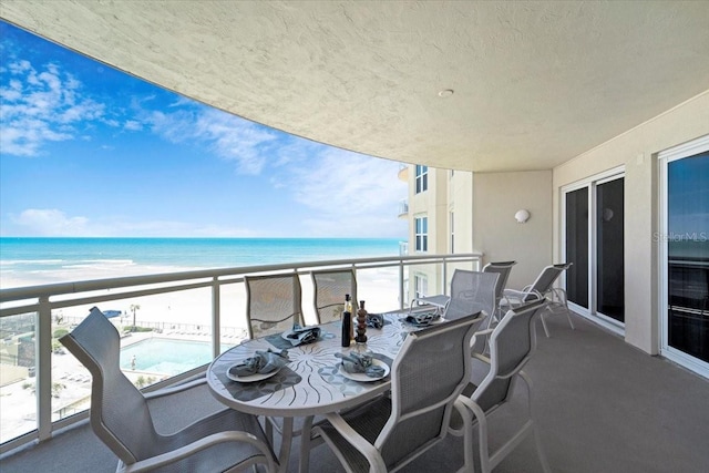 balcony with a view of the beach and a water view