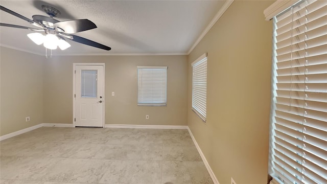 empty room with a textured ceiling, ceiling fan, and crown molding