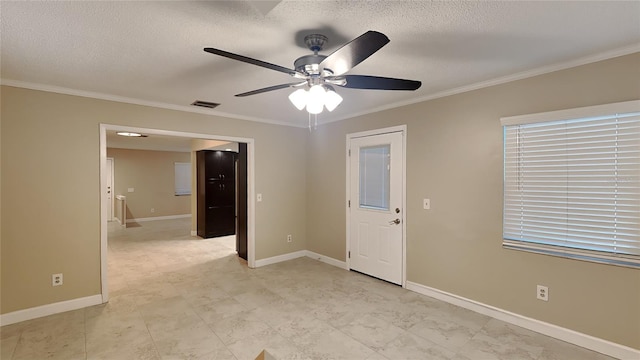 unfurnished room with a textured ceiling, ceiling fan, and ornamental molding