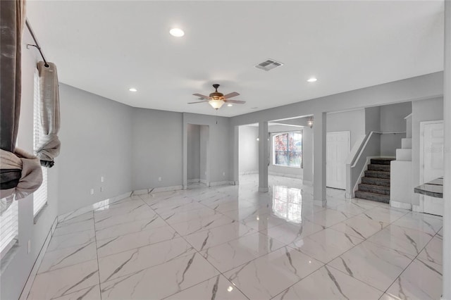 unfurnished living room with ceiling fan