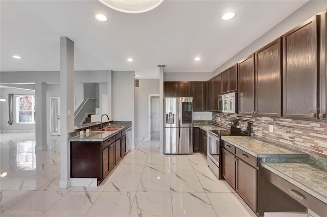 kitchen featuring dark brown cabinetry, sink, stainless steel appliances, tasteful backsplash, and light stone counters