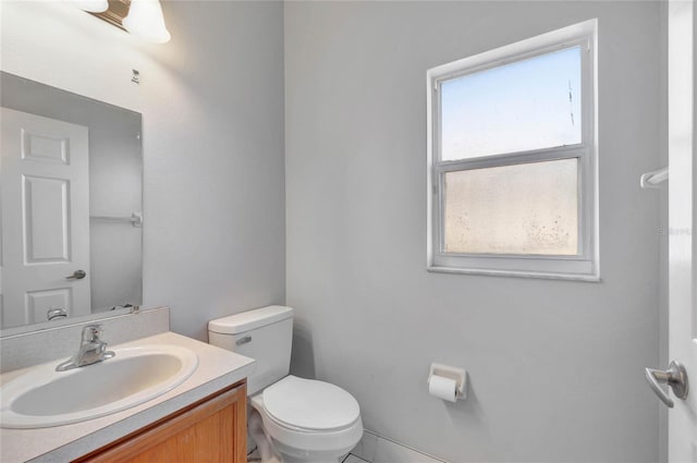 bathroom featuring tile patterned flooring, vanity, and toilet