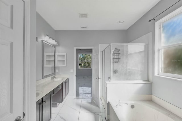 bathroom featuring vanity and independent shower and bath