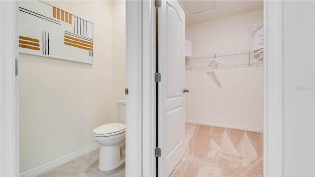 bathroom featuring tile patterned flooring and toilet