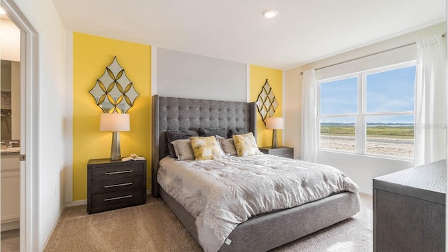 bedroom featuring light colored carpet