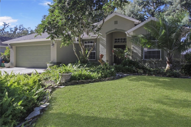 view of front of property featuring a front lawn and a garage