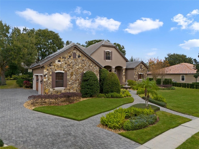 view of front facade with a garage and a front lawn