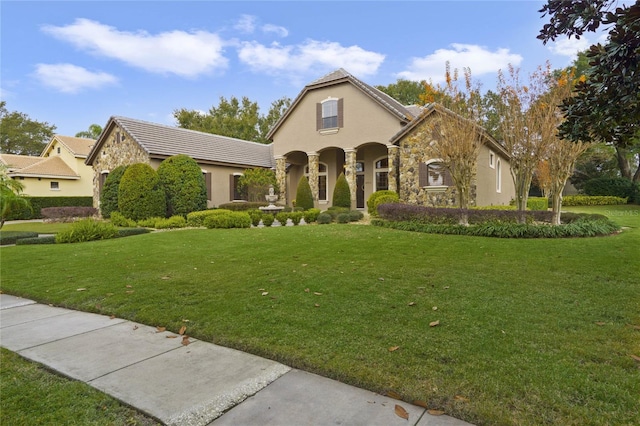 mediterranean / spanish house with a front yard