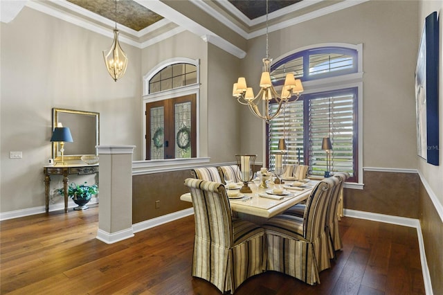 dining area with dark hardwood / wood-style floors, an inviting chandelier, and crown molding