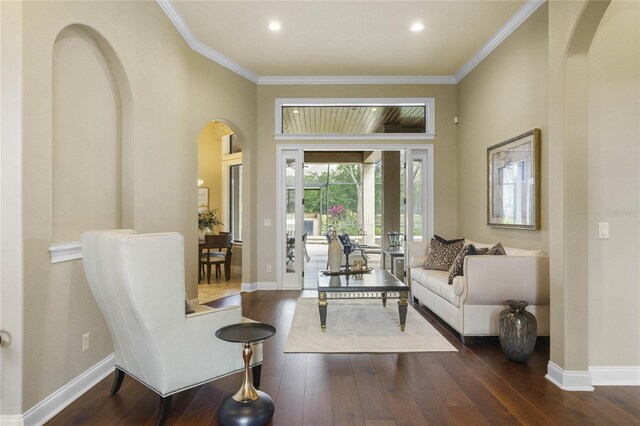 sitting room featuring ornamental molding, french doors, and dark wood-type flooring