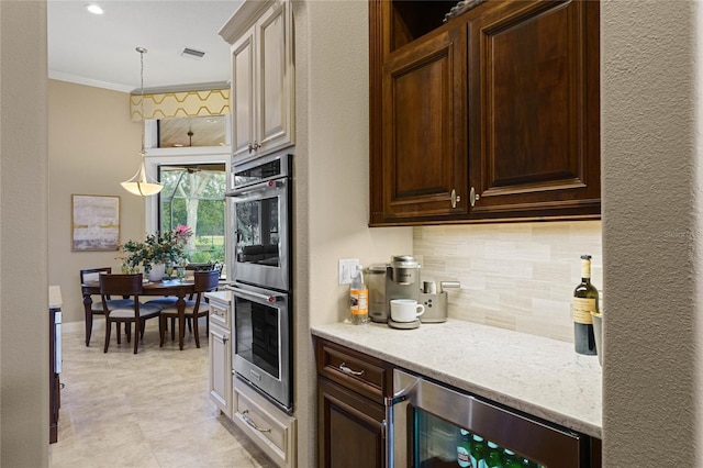 kitchen with crown molding, light stone countertops, tasteful backsplash, stainless steel double oven, and beverage cooler