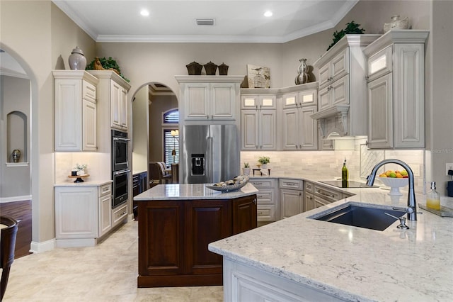 kitchen with white cabinets, crown molding, sink, and appliances with stainless steel finishes