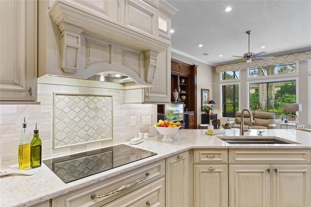 kitchen featuring sink, tasteful backsplash, premium range hood, crown molding, and black electric cooktop