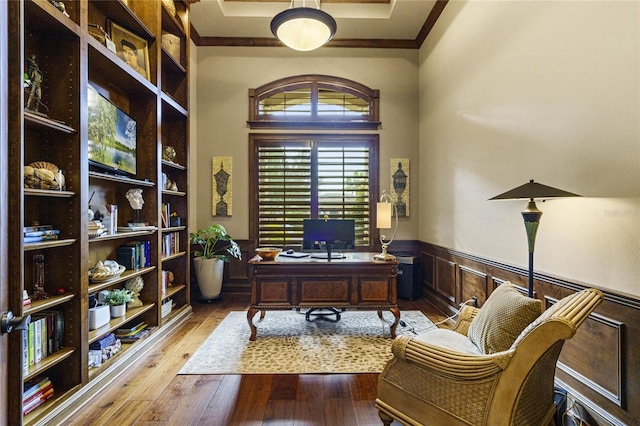 home office with light hardwood / wood-style floors and ornamental molding