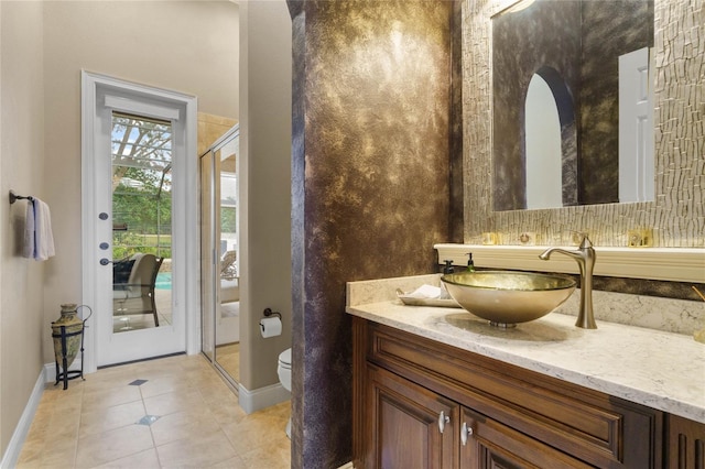 bathroom with tile patterned flooring, vanity, and toilet