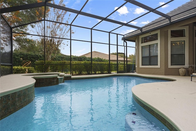 view of pool with glass enclosure and an in ground hot tub