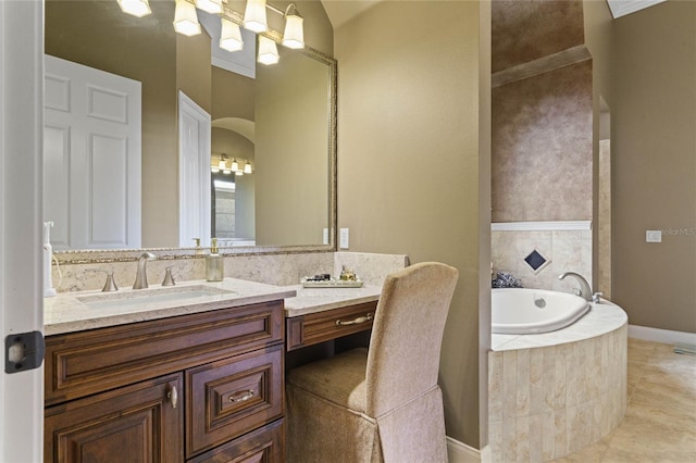 bathroom with tile patterned flooring, a relaxing tiled tub, and vanity