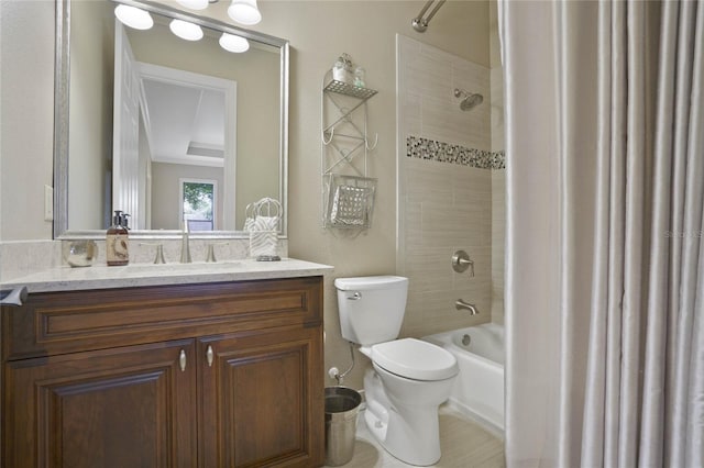 full bathroom featuring tiled shower / bath, vanity, and toilet