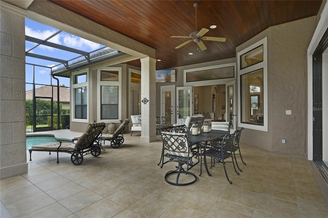 view of patio featuring ceiling fan and a lanai