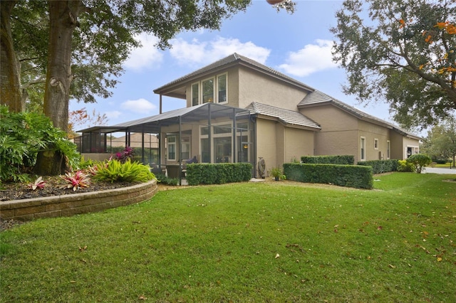 rear view of house featuring a yard