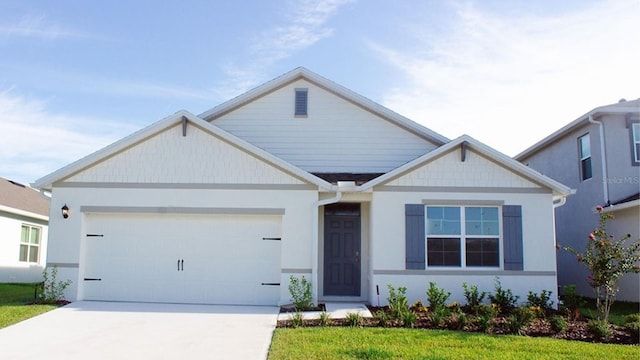 view of front of property with a garage and a front lawn