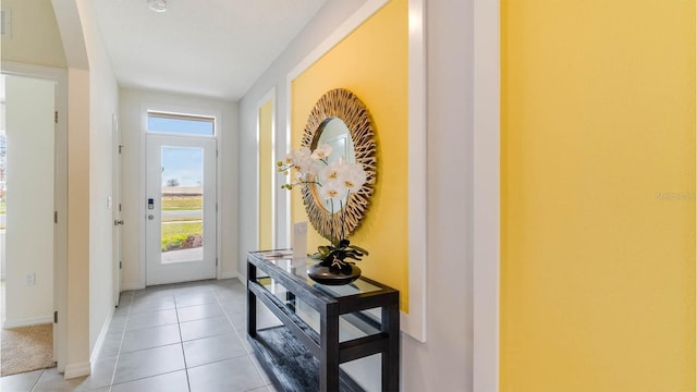 doorway to outside featuring light tile patterned floors