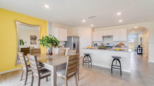 dining space featuring light tile patterned flooring