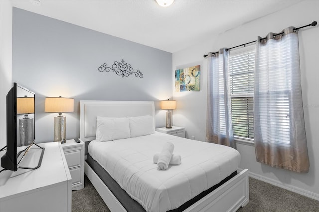 carpeted bedroom featuring multiple windows