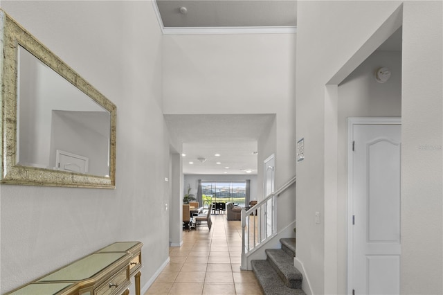 entryway featuring crown molding and light tile patterned flooring